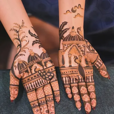This is a beautiful example of a modern, picturesque mehandi design. It features architectural domes and peacocks, but with more open space than traditional designs, making it perfect for festivals.