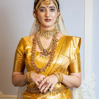 A classic South Indian bridal look featuring a stunning gold Kanjeevaram saree. I created a warm, golden makeup look with defined eyes and a traditional matha patti, ensuring the bride looks regal and radiant.