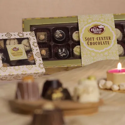Our Soft-Center Chocolates are a delightful surprise, available in elegant gift boxes. This image showcases the beautiful packaging, perfect for gifting.