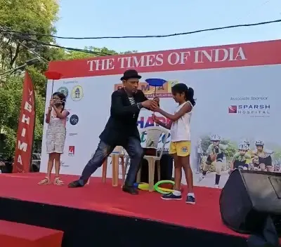 A magician engages with children on stage at an outdoor family day event for a corporate client. I organize entertainment suitable for all ages to ensure company family days are a success.