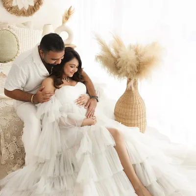 A dreamy and ethereal maternity portrait. The flowing white tulle gown and soft lighting in my boho studio setup create a truly magical and timeless image for this mama-to-be.