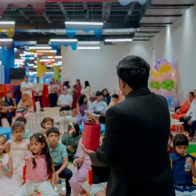 Kicking off a birthday magic show for an excited group of kids. I love seeing them all gathered and ready for the surprises to begin. This kind of setup is great for party halls and dedicated event spaces.
