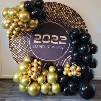 I designed this glamorous New Year's Eve photo booth to be the centerpiece of the party. It features a large circular backdrop with a sparkling sequin finish, bold "2022 Happy New Year" text, and an organic arrangement of chrome gold and matte black balloons to create a sophisticated look.