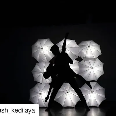A stunning silhouette of a dance pair performing at our "I Will Dance" showcase at Alliance Francaise. We use creative props like these lit-up umbrellas to make our stage performances visually unforgettable.