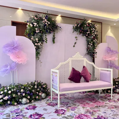 A dreamy lavender setup for Rahil and Sadiya's Baat Pakki. We used a floral-printed floor, large handmade tulle flowers, and a beautiful white bench to create a whimsical and romantic setting.