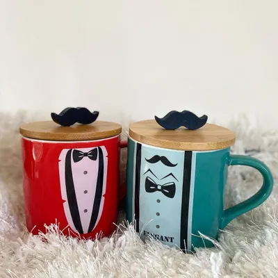We offer a range of individual gift items, like these "Elegant Man" mugs. Available in red and teal, they feature a fun tuxedo design and a wooden lid with a mustache handle, making them a great standalone gift or an add-on to a larger hamper.
