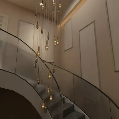 For this Gurgaon residence, I designed a breathtaking foyer around a double-height cascading chandelier. This statement piece immediately establishes a sense of luxury and grandeur, drawing the eye upward and filling the voluminous space.