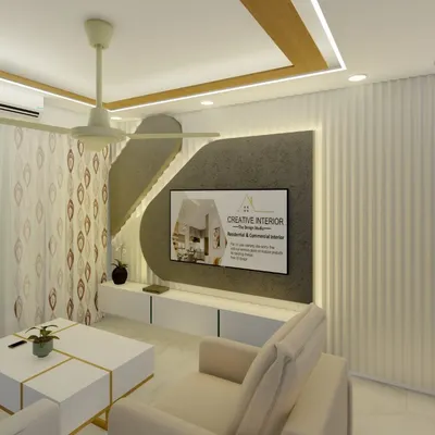 This living room features a custom TV unit with a textured background panel and integrated lighting. We used a neutral color palette with white furniture and gold accents to create a bright and modern living space.