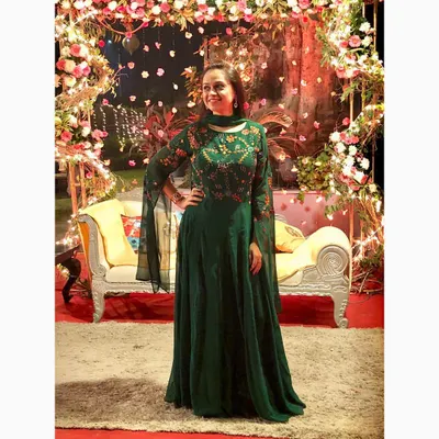 An emerald green Anarkali gown makes a sophisticated statement at any wedding function. The playful bell sleeves are a current trend, while the intricate embroidery on the bodice adds a touch of timeless grace.