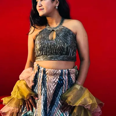 Stand out at any party with this glamorous sequined lehenga with a halter neck top. This is a perfect example of the modern and stylish outfits you can rent from my studio for your special occasions.