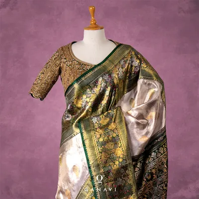 A masterpiece of hand-embroidery, this blouse is fully covered in dense, intricate gold threadwork. The design features traditional floral and paisley motifs, creating a rich, tapestry-like effect that is the epitome of bridal luxury.