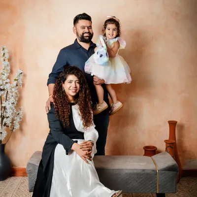 A beautiful family portrait against an earthy, textured backdrop. I guide families into comfortable poses that feel natural, allowing their personalities to shine through.