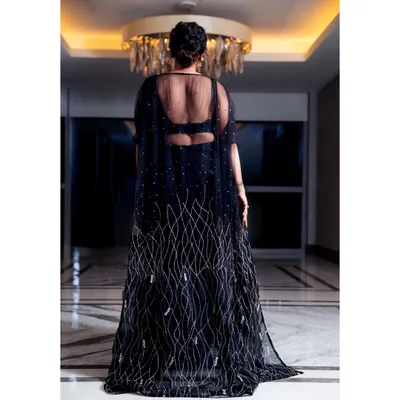The back of this stunning black gown I designed for Anupama Gowda. It features a sheer cape with delicate silver embroidery, creating a dramatic and elegant silhouette that is perfect for a grand entrance.