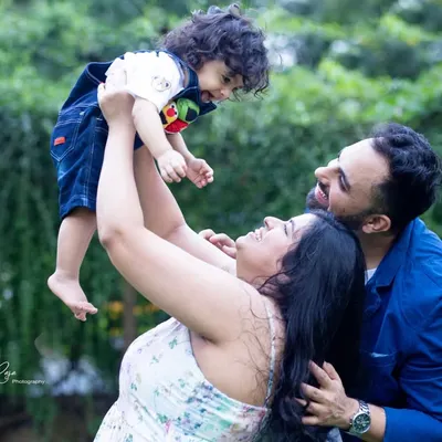 The pure joy of being lifted in the air. I love capturing these vibrant, playful moments during outdoor family photoshoots.