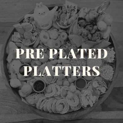 An introduction to our pre-plated platters. This black and white image showcases a chai board, highlighting the variety and abundance we pack into every single platter we create.
