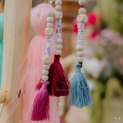 It's the little things. For this event, we created custom tassels with lettered beads spelling out words like 'LOVE' and 'RHYTHM', adding a playful and personal touch.