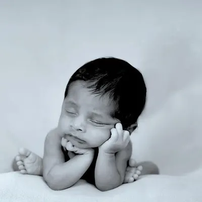 The peaceful sleep of a newborn. We capture these delicate moments in classic black and white to create timeless art for your home.