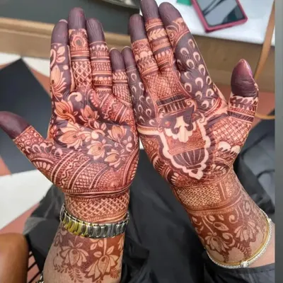 A close-up of a full-hand bridal style mehndi, showing the deep color achieved with my natural henna. The design combines floral patterns with traditional Indian motifs.