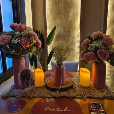 An intimate and personalized table setup for two. We used custom placemats, floral arrangements, and candles to create a romantic dinner setting.