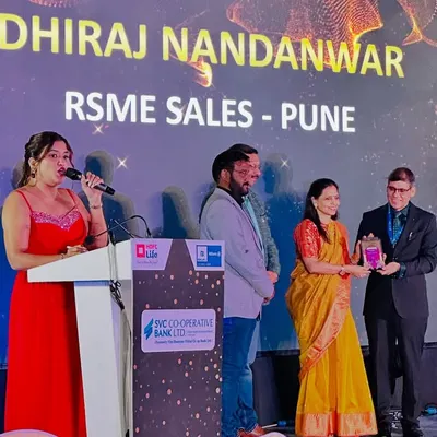 On stage at the HDFC Life & SVC Bank awards ceremony in Jaipur. It is an honor to announce the winners and celebrate their achievements in the finance sector.