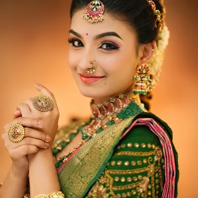 A close-up of a classic South Indian bridal look. You will learn how to create this radiant skin finish and perfectly defined eye makeup that complements traditional gold jewelry.