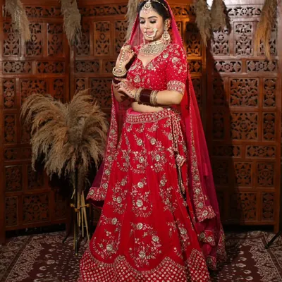 This classic red bridal lehenga is a dream come true for any bride. I've designed this piece with rich velvet and detailed embroidery to make sure you feel like royalty on your special day. Since I manufacture my own collection, I can offer this stunning look at a price that makes sense.