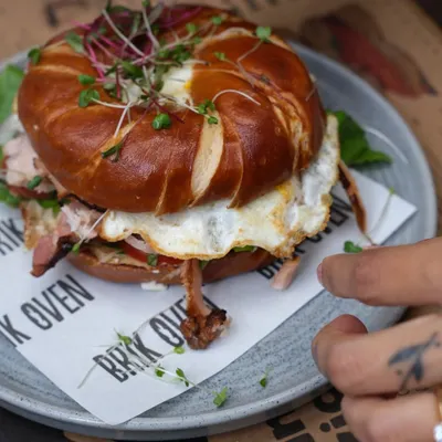 Our pretzel bagel sandwich, loaded with a fried egg and savory ham. The unique flavor of the lye-dipped pretzel bagel makes this a breakfast you won't forget.