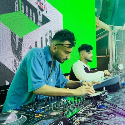 In the booth with my partner. We work together to manage the sound and visuals, ensuring a seamless show from start to finish.
