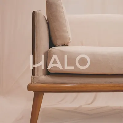 The 'Halo' sofa, crafted from the rich, warm tones of teak wood and softened by the luxurious embrace of fabric cushions. This is where comfort meets artistry.