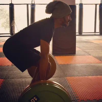 The setup is everything in a deadlift. Here I am demonstrating the correct starting posture, ensuring a flat back and proper engagement of the legs and core before initiating the lift. This focus on technique is key to safe and effective strength training.
