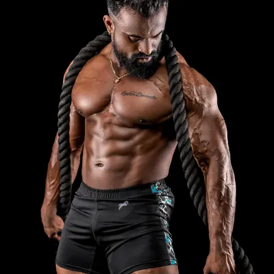 A professional shot showcasing my chest and shoulder development while holding battle ropes. This physique is built to be both aesthetic and functional.