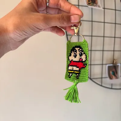 Here's a custom keychain I made featuring Shinchan. The design is created by knotting individual threads to form the pixel-like image, complete with his signature red shirt.