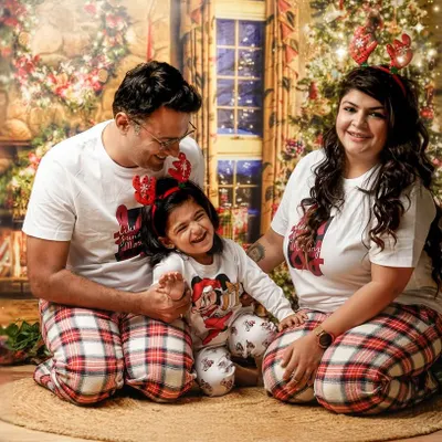 The best gift is family. This joyful family portrait, with everyone in matching Christmas pajamas, perfectly captures the warmth and happiness of the holiday season in our festive studio.