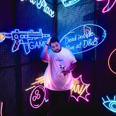 Me in my element, surrounded by neon lights. The vibrant colors and energy of places like this inspire the music I create.