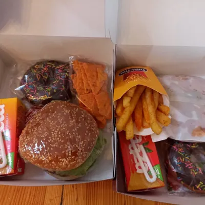 Burgers, chocolate donuts and fries fill these two snack boxes we pack for individual servings at a party.