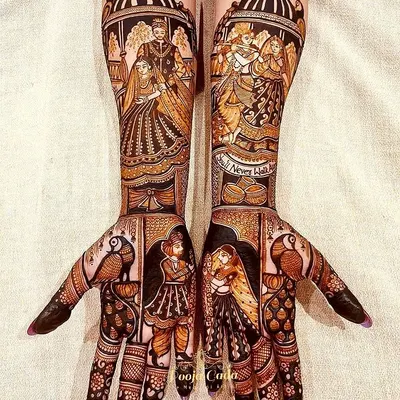 This is a masterpiece of storytelling henna. The design incorporates portraits of the couple, a depiction of Radha and Krishna, and other figures from the wedding ceremony, creating a complete narrative on the arms.