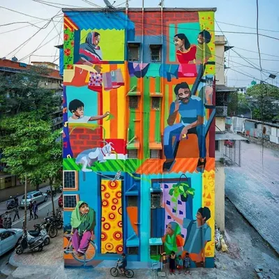 This vibrant, multi-story mural titled "Me/We" captures the spirit of community in Mumbai. It's a colorful depiction of daily life, showing different families and individuals coexisting in a single building, a true reflection of the city's soul.