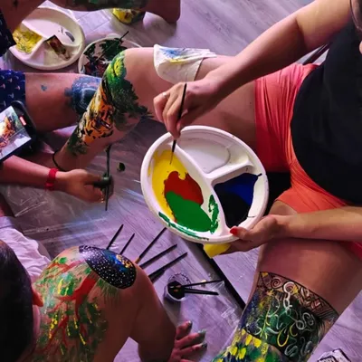 The beautiful, messy result of a body painting workshop. Participants use each other as canvases, exploring creativity and connection in a very personal and tactile way. It is an experience of pure, uninhibited expression.