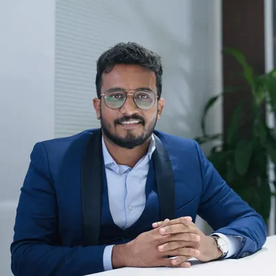 A professional portrait from my office. While I take my work seriously, I always aim to be approachable and create a welcoming environment for my clients and team.
