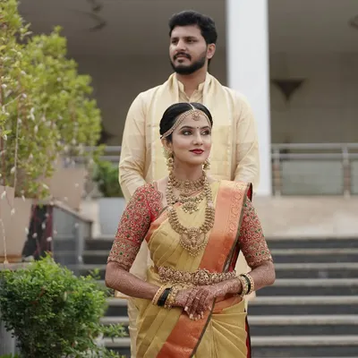 My stunning bride Taanya, looking absolutely regal in a golden Kanjivaram saree paired with a custom red embroidered blouse for her muhurtham.