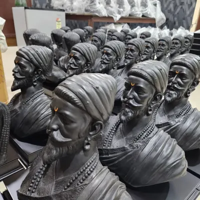 A close-up of the finished Chhatrapati Shivaji Maharaj busts. Each piece is carefully crafted with a consistent dark metallic finish and a tilak detail.