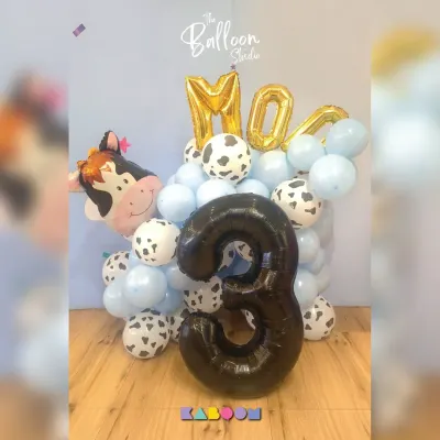 Moo-ve over boring decorations! This adorable farm-themed balloon bouquet features a cow balloon, cow-print accents, and a large number three for a fun-filled third birthday.