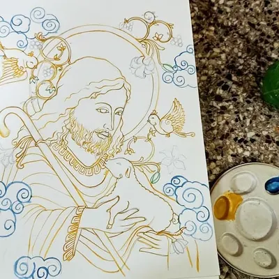 The process begins with precise line work in a golden-yellow hue, a characteristic of Kerala mural art. This image shows the underlying drawing for the 'Jesus, The Good Shepherd' piece before the vibrant colors are filled in.