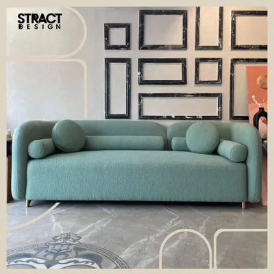 Our "Cloud" sofa, shown here in a full view, features a dreamy, rounded form and is upholstered in a lush moss green bouclé fabric. It's a perfect centerpiece that combines contemporary design with a serene, inviting feel.