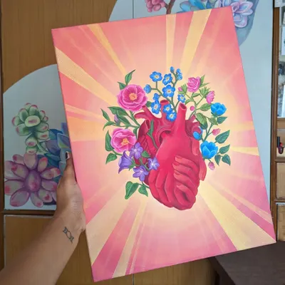 A finished canvas painting featuring a floral anatomical heart, glowing with warm light. This piece combines my love for botanical elements with a surreal concept, creating a powerful and beautiful image. These paintings are available as custom commissions.