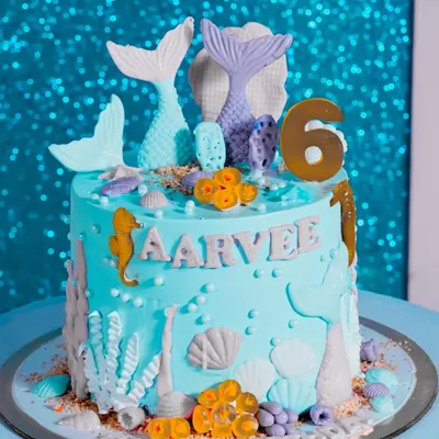 An incredible mermaid-themed cake, complete with tails, seahorses, and shells. We capture the artistry of your custom cake.