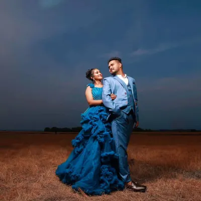 A dramatic, moody shot from a pre-wedding session. I styled the groom in a sharp light blue three-piece suit to perfectly match the bride's ruffled gown.