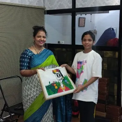 Anaya, an 8th standard student, with her finished tote bag art. She used acrylics on the jute bag to create a unique design inspired by Frida Kahlo.