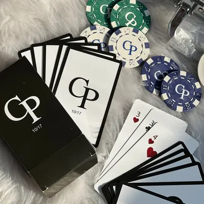 A close-up of the custom-designed playing cards and chips from our personalized poker set. The couple's initials and a special date make it a one-of-a-kind wedding gift.