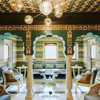 For the Surya Haveli in Jaipur, I designed a series of wallpapers that celebrate the city's rich heritage. This sitting area features multiple patterns, from geometric ceilings to arched murals, creating a truly royal experience.